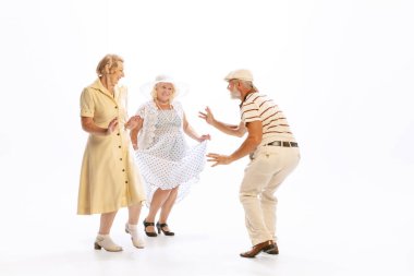 Social dances. Handsome senior man and two charming women in vintage retro style outfits dancing isolated on white background. Concept of relations, family, 1960s american fashion style and art. clipart