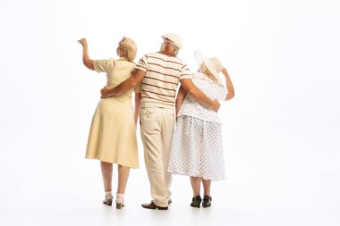 Dating. Handsome senior man and two charming women in vintage retro style outfits isolated on white background. Concept of relations, family, 1960s american fashion style and art.