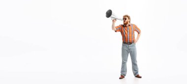 Attention. Portrait of young man dressed in 50s, 60s fashion style outfit posing isolated on white background. Concept of modern culture, beauty and ad. Cyclical fashion. Copy space for ad