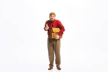 Nerd. Portrait of young man dressed in 50s, 60s fashion style outfit posing isolated on white background. Concept of modern culture, beauty and ad. Cyclical fashion. Copy space for ad
