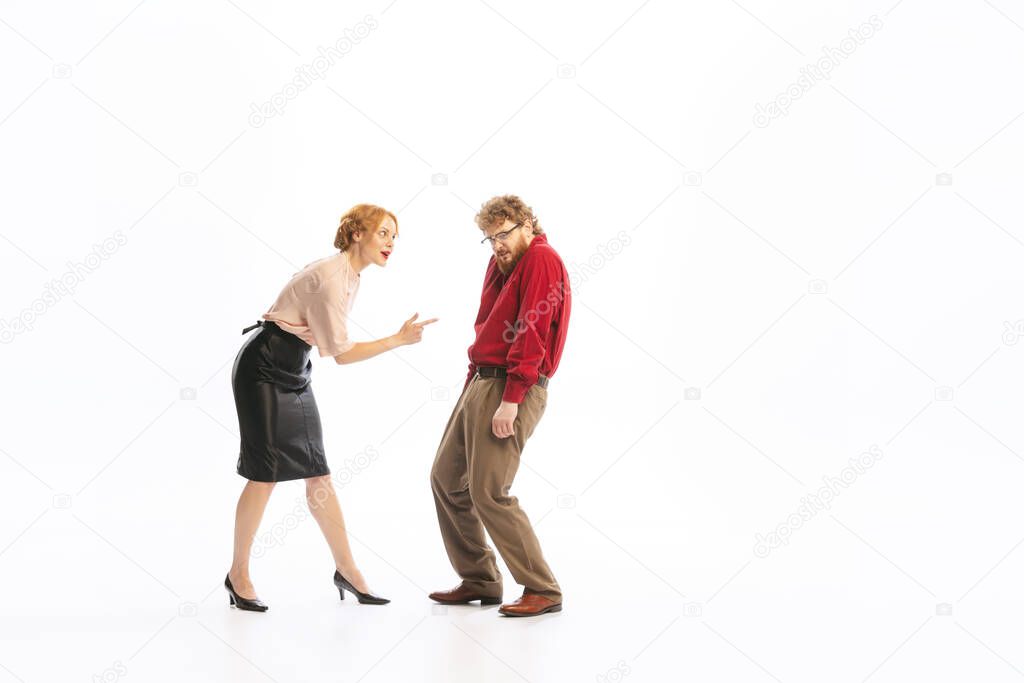 Family couple in vintage outfits sort things out isolated on white background. Concept of relationship, family, feminism, psychology of personality. Couple look emotional