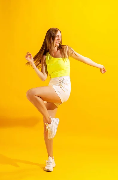 Enjoying Freedom Astonished Young Girl Student Dancing Isolated Bright Yellow — 图库照片