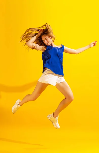 Freestyle Happy Young Girl Student Jumping Isolated Bright Yellow Background — 图库照片