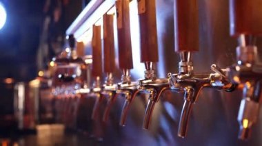 The beer taps in a pub. nobody. Selective focus. Alcohol concept. Vintage style. Beer craft. Bar table. Steel taps. Shiny taps. Video, 4k