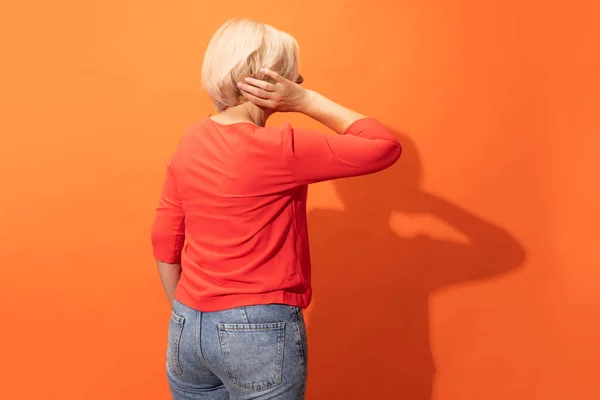Back View Middle Age Woman Blond Hair Posing Isolated Orange — Fotografie, imagine de stoc
