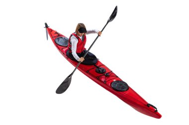 Aerial view of young woman in red canoe, kayak with a life vest and a paddle isolated on white background. Concept of sport, nature, travel, active lifestyle. Copy space for ad