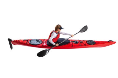 Aerial view of young woman in red canoe, kayak with a life vest and a paddle isolated on white background. Concept of sport, nature, travel, active lifestyle. Copy space for ad