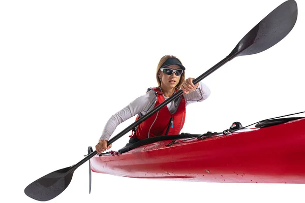 Energy. Young woman, sportsman in red canoe, kayak with a life vest and a paddle isolated on white background. Concept of sport, nature, travel, active lifestyle
