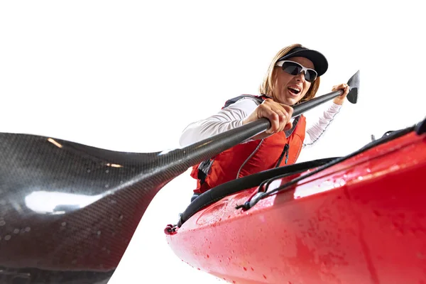 Closeup. Young woman, sportsman in red canoe, kayak with a life vest and a paddle isolated on white background. Concept of sport, nature, travel, active lifestyle