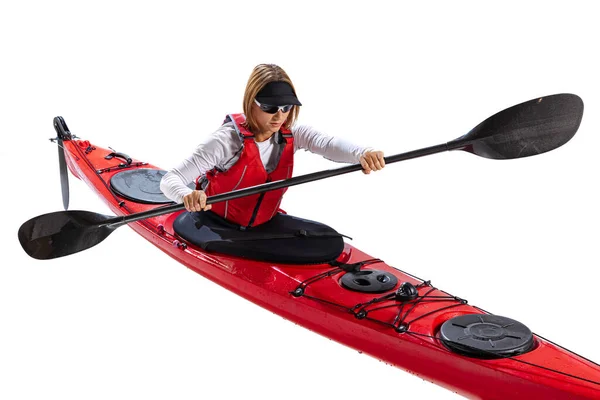 water sport activities. Young woman, sportsman in red canoe, kayak with a life vest and a paddle isolated on white background. Concept of sport, nature, travel, active lifestyle