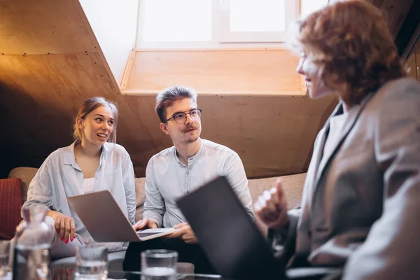 Designer meeting with customers. Group of happy, motivated young people discussing plans and projects. Coworkers working at office, indoors. Concept of business, teambuilding