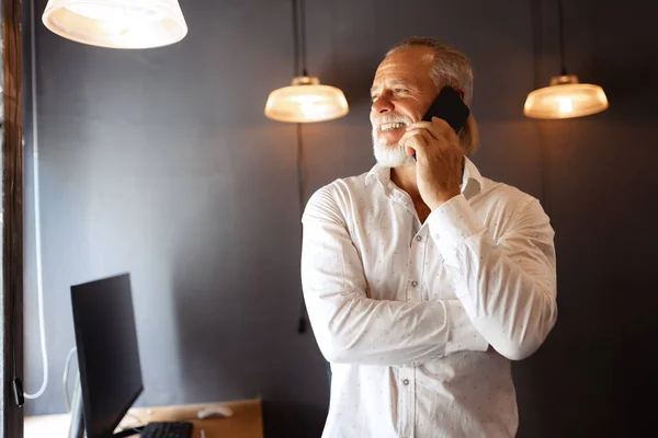 Handsome Senior Man Talking Phone Smilling Ceo Works Modern Loft — Stok fotoğraf