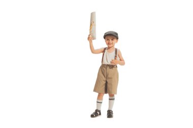 Paperboy, newsboy. Cute happy kid in retro style shorts holding newspaper isolated on white studio background. Vintage style concept. Friendship, hobbies, art, eras comparison and children emotions clipart