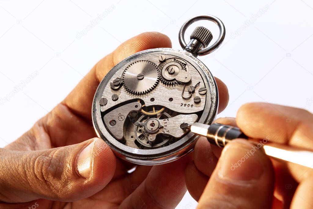 Restoration, repair. Closeup watchmakers hands repairing mechanical watches isolated over white background. Concept of vintage retro mechanisms, job, work, ad
