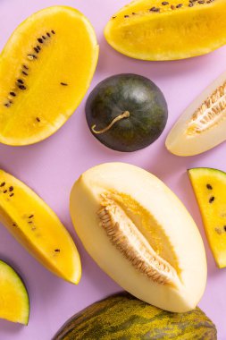 Healthy and tasty. Top view of ripe fresh watermelon and melon slices over colorful background. Design for wallpaper, greeting season card, ad, sales. Summer vitamins, berries. Closeup.