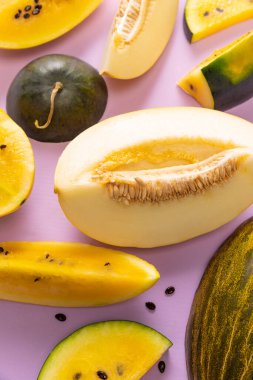 Closeup ripe juicy watermelon and melon, slices over colorful background. Design for wallpaper, greeting season card, ad, sales. Summer vitamins, berries. Closeup.