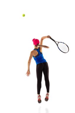 Training of female tennis player practicing power serving isolated on white background. Sports emotions, healthy lifestyle, fitness, sport, achievements concept. Young girl in sports uniform