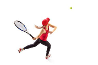 Training of female tennis player practicing power serving isolated on white background. Sports emotions, healthy lifestyle, fitness, sport, achievements concept. Young girl in sports uniform