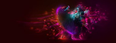 Viennese waltz, tango, slow foxtrot. Young beautiful couple, man and woman dancing ballroom dance over dark background with colorful neon elements. Art, music, dance style concept. Open dance cup.