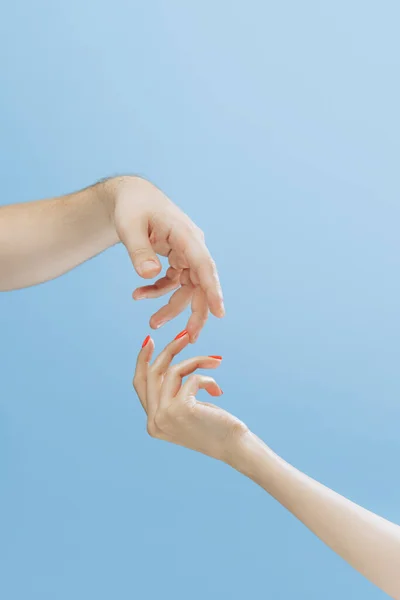 Touch. Graceful female hands gesturing isolated on blue background. Concept of relationship, feelings, community, care, support, symbolism, art. Copy space for ad