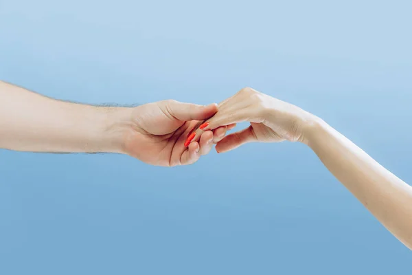 Touch. Graceful female hands gesturing isolated on blue background. Concept of relationship, feelings, community, care, support, symbolism, art. Copy space for ad