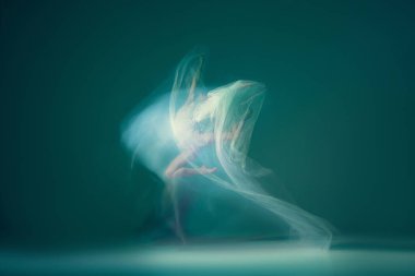 Light weightless gait of ballerina similar to smooth movement of cloud isolated over cyan color background. Art, beauty, aspiration, flexibility, inspiration concept. Blurring effect, mixed light