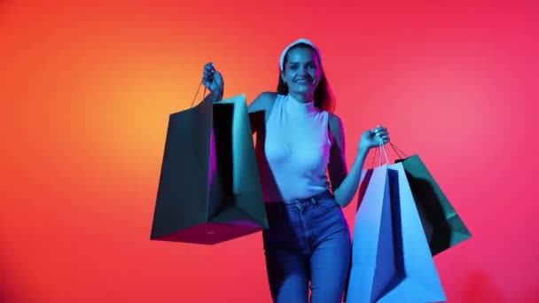 Fashionable Happy Young Girl Dancing Shopping Packages Bags Isolated Magenta — Stockvideo