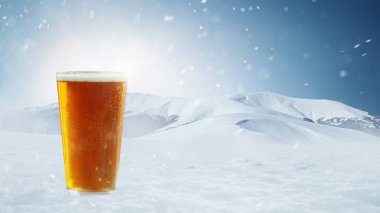Poster with glass of light cold foamy beer over snow-capped mountains background. Holidays, vacation, drinks, taste, ad and oktoberfest concept. Design for wallpaper, greeting card