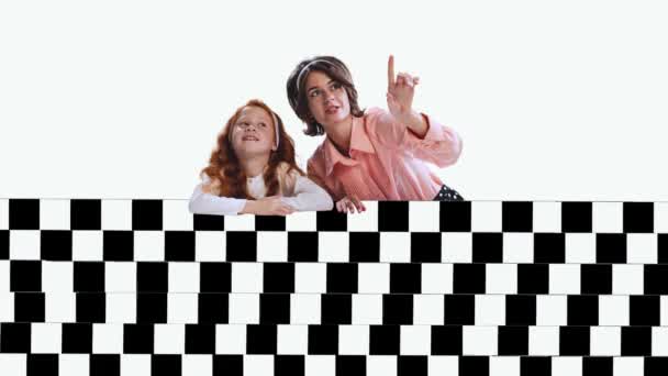 現代美術のコラージュ 若い女性と少女 母親と娘の黒と白の光の幻想的なデザイン 光の背景にパターンの後ろに座っている シュルレアリスム 創造性 想像力の概念 — ストック動画