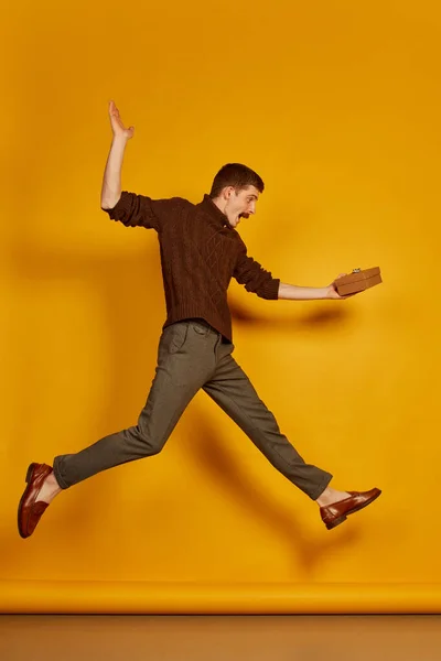 Portrait Young Cheerful Man Jumping Joy Present Box Isolated Yellow — Stock Photo, Image