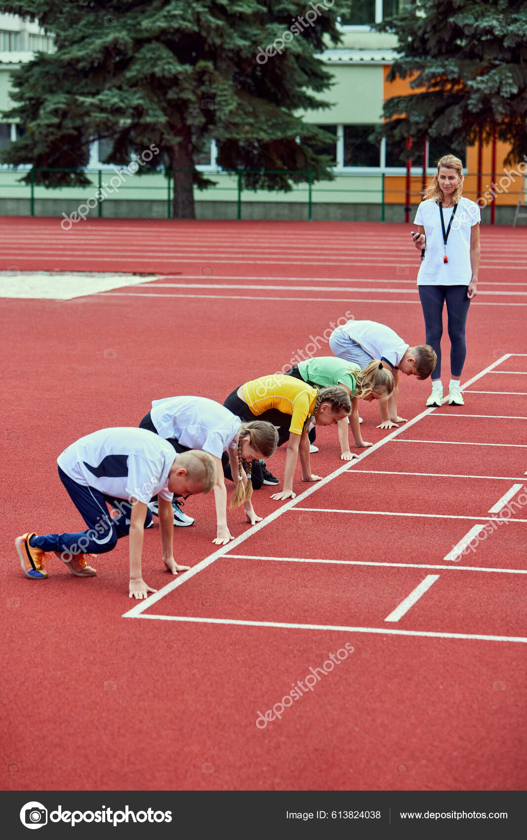 Female Coach Training Athletes Start Group Children Preparing Run