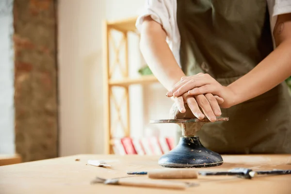 Clay modeling process, learning the basics of pottery. Young female pottery master with supplies recording vlog at home studio. Hobbies and leisure activities. Remote training, online classes, ad