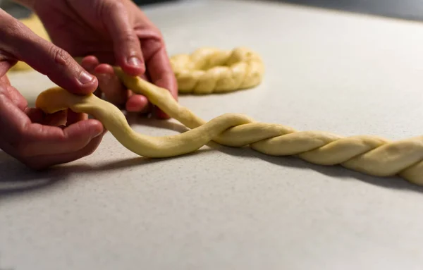 Female Hands Braiding Dough White Table Close — стоковое фото