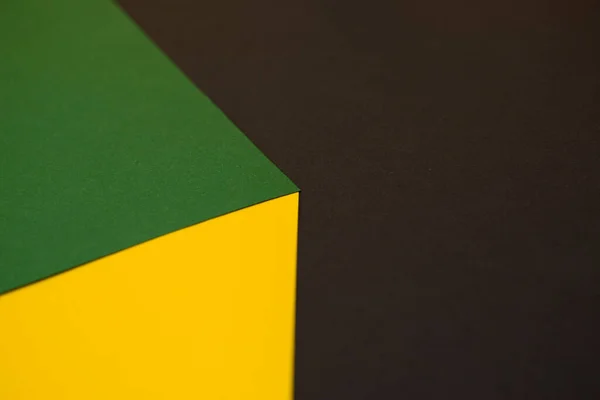 3d optical illusion, green and yellow cube on black background