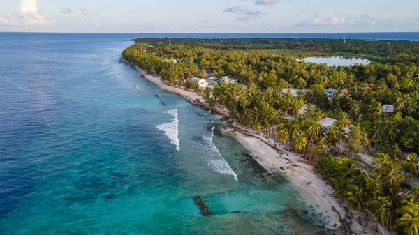 Aerial view of tropical beach landscape at Fuvahmulah island, a famous dive site for tiger sharks in South Maldives. Summer holiday and vacation travel concepts