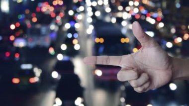 Security shield with check mark icon on finger over blur colourful night traffic jam road with cars in city, Technology internet cyber security and anti virus concept