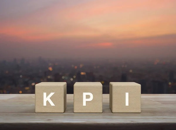 Kpi Letter Wood Block Cubes Wooden Table Blur Cityscape Warm — стоковое фото