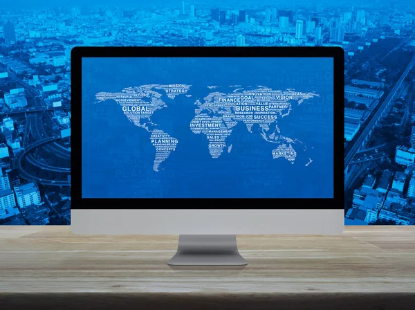 Global business words world map on desktop modern computer monitor screen on wooden table over city tower, street, expressway and skyscraper, Global business online concept, Elements of this image furnished by NASA