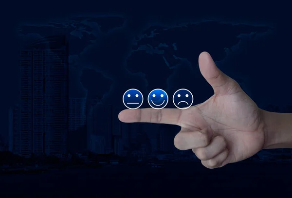 Excellent smiley face rating icon on finger over world map, city tower and skyscraper, Business customer service evaluation and feedback rating concept, Elements of this image furnished by NASA