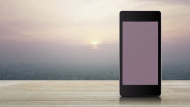 Motorcycle delivery flat icon on modern smart mobile phone screen on wooden table over city tower and skyscraper at sunset, vintage style, Business delivery service online concept