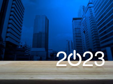 2023 start up business flat icon on wooden table over modern office city tower and skyscraper, Happy new year 2023 cover concept