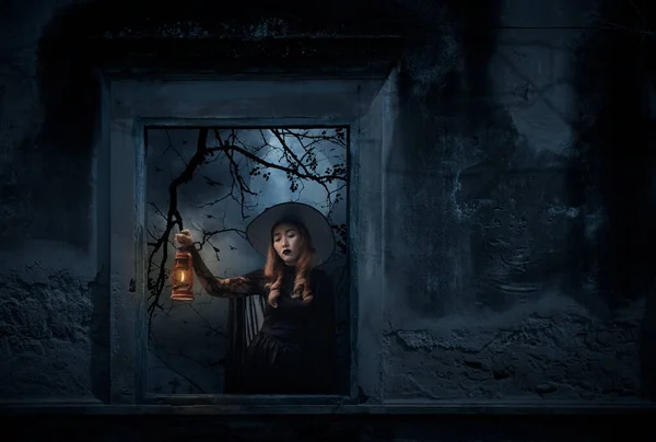 Halloween Witch Holding Ancient Lamp Standing Old Damaged Window Wall — Stock Photo, Image