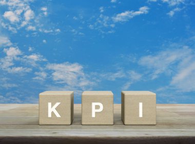 KPI harfi ahşap küpler üzerinde ahşap masa üzerinde beyaz bulutlu, anahtar performans göstergesi iş hedefi konsepti