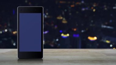 e learning flat icon on modern smart mobile phone screen on wooden table over blur colorful night light city tower and skyscraper, Business study online concept