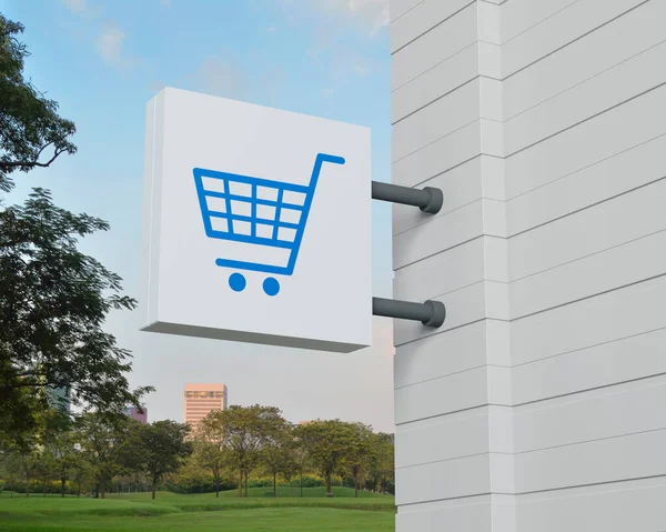 Shop cart icon on hanging white square signboard over green grass field and trees in park, Business shopping online concept, 3D rendering