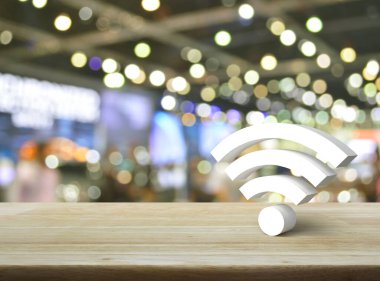 Wi-fi 3d icon on wooden table over blur light and shadow of shopping mall, Technology internet communication concept