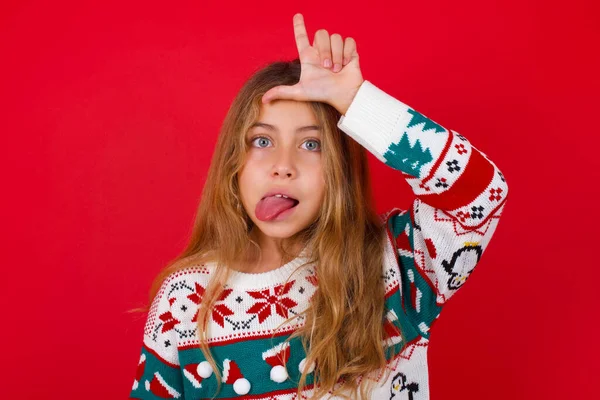 Schöne Mädchen Weihnachtspulli Gesten Mit Dem Finger Auf Der Stirn — Stockfoto