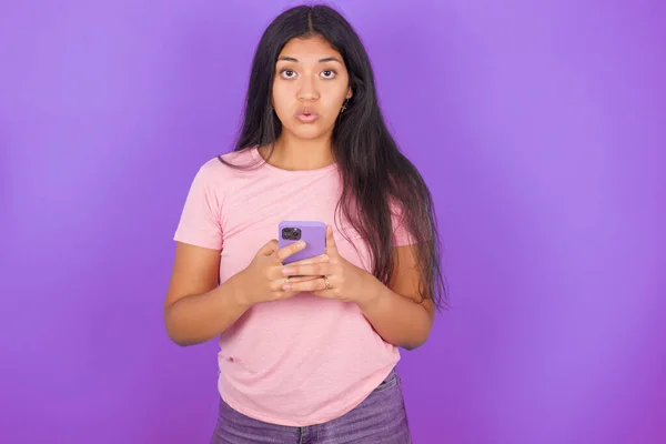 Sorprendido Chica Morena Hispana Con Camiseta Rosa Sobre Fondo Púrpura —  Fotos de Stock