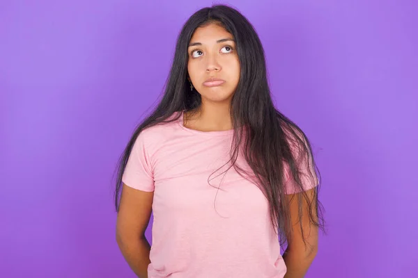 Dissatisfied Young Hispanic Girl Wearing Pink Shirt Purple Background Purses — Stock Photo, Image