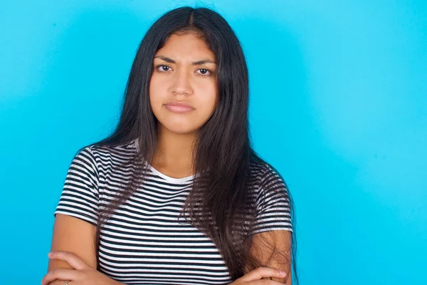 Young Hispanic Girl Wearing Striped Shirt Blue Background Crossing Arms — Stock Photo, Image